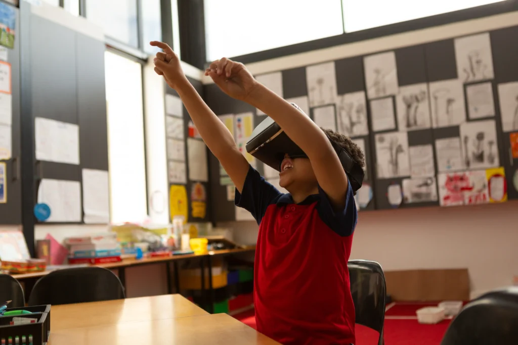 A Boy reaches for something in the virtual world he is interacting with in virtual reality.