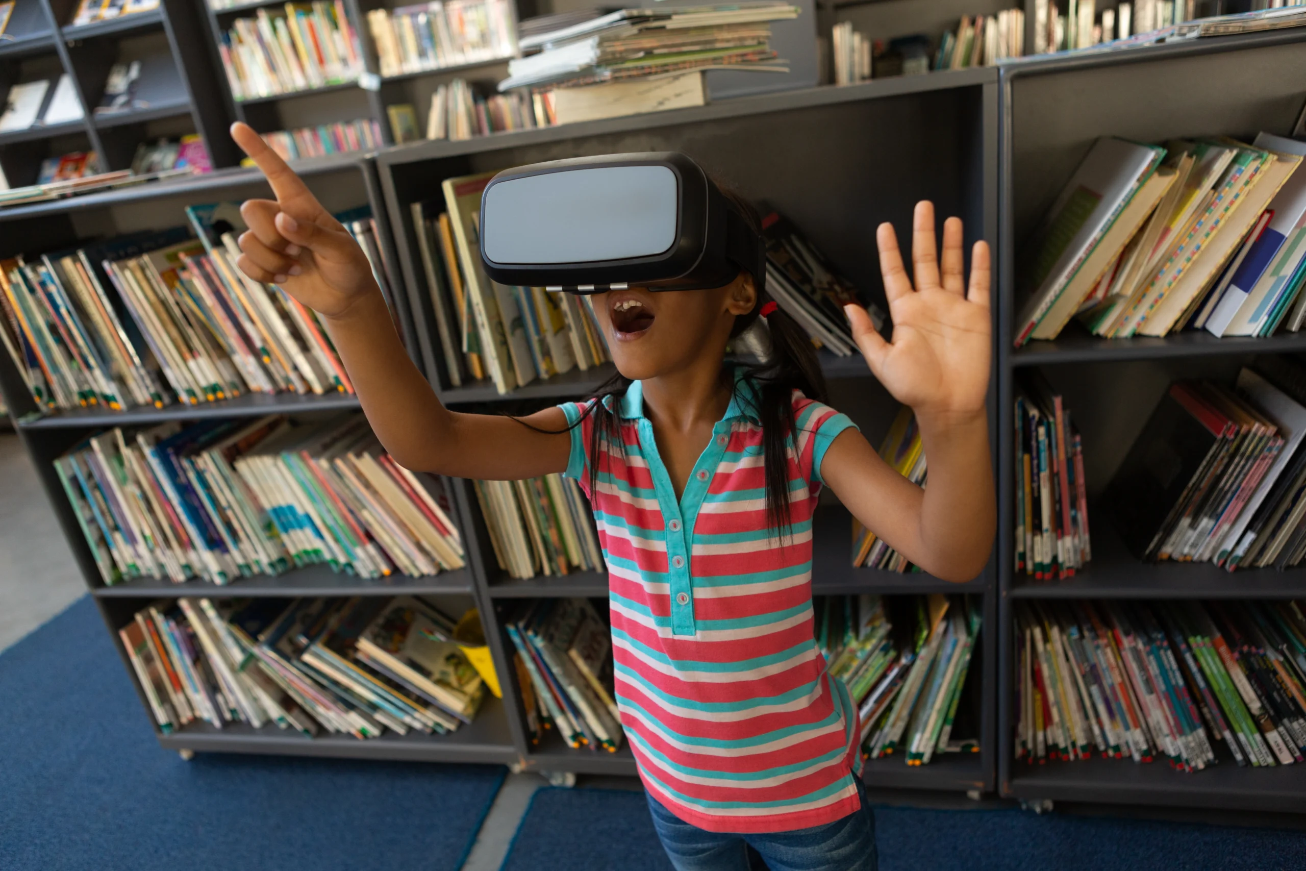 Middle School Girl in Library Using VR Headset. She is actively engaged in her learning.